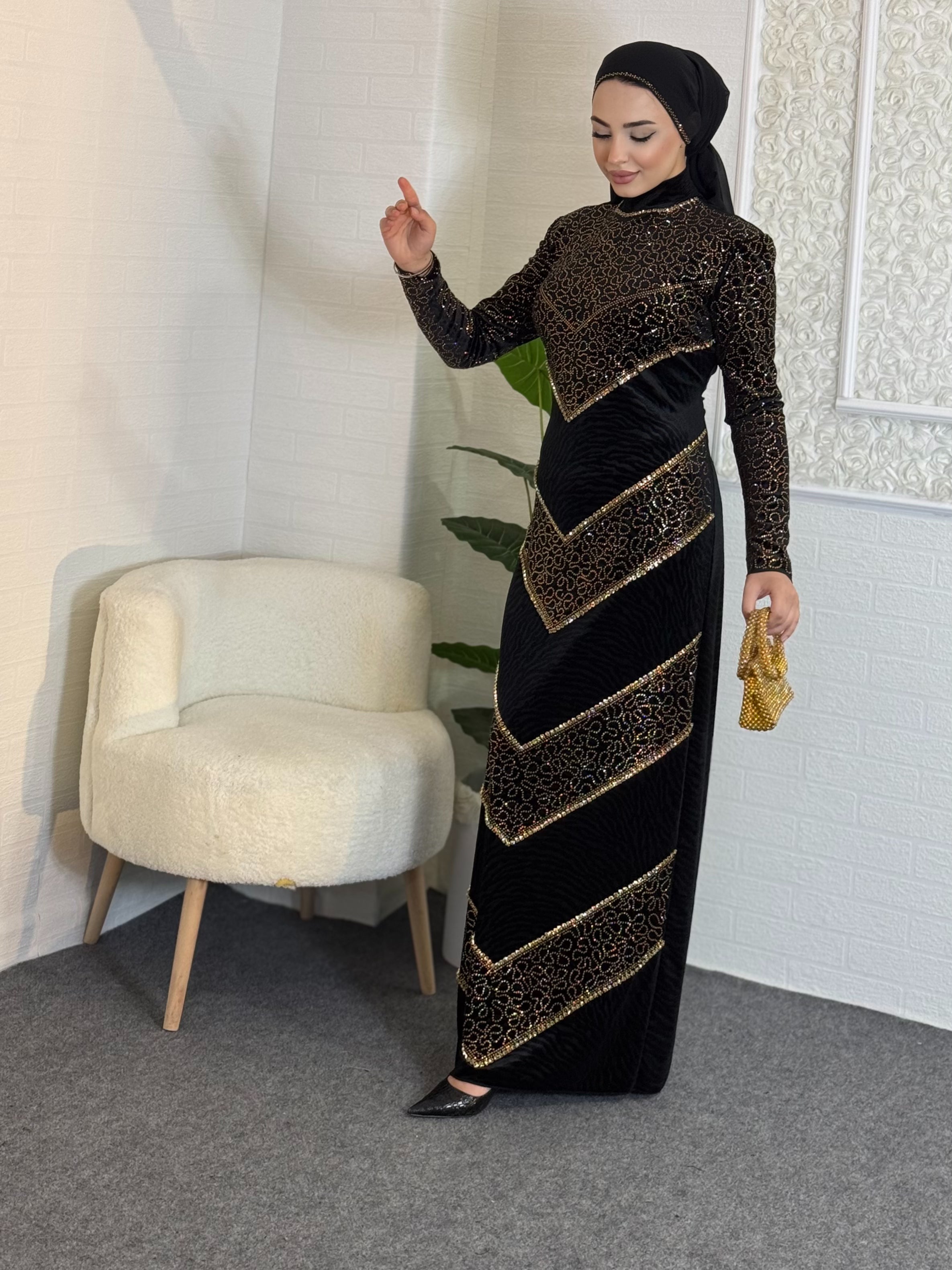 Black velvet evening dress decorated with gold stones