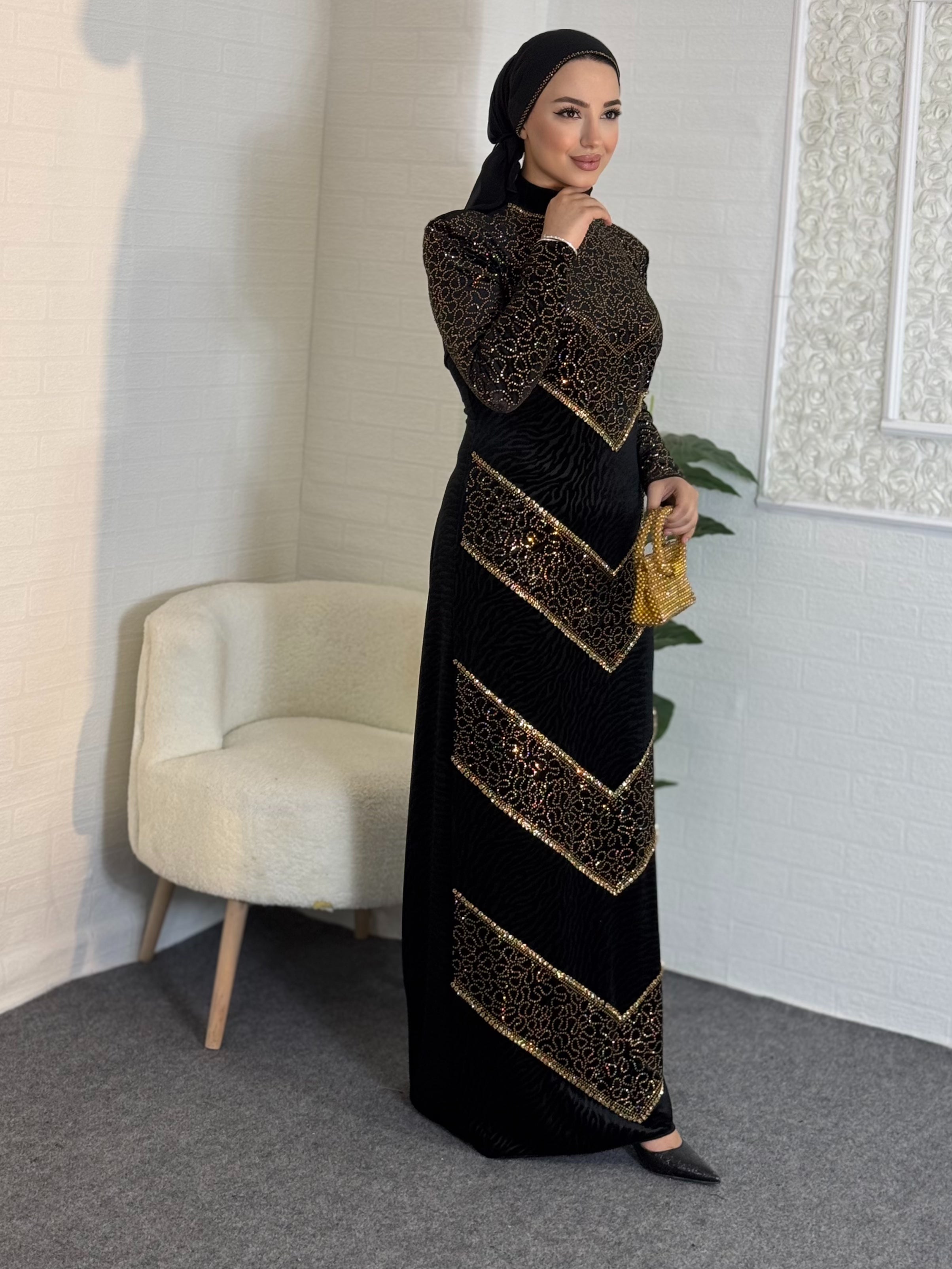 Black velvet evening dress decorated with gold stones