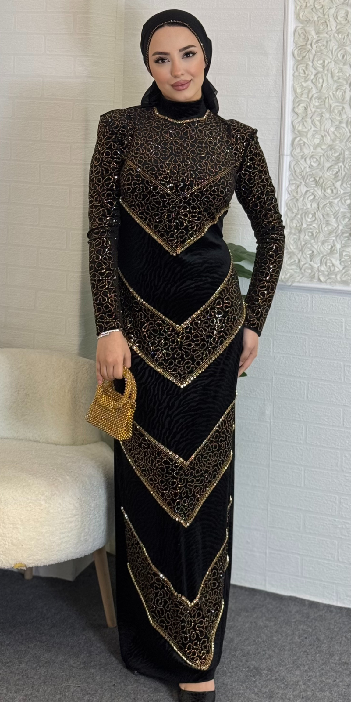 Black velvet evening dress decorated with gold stones