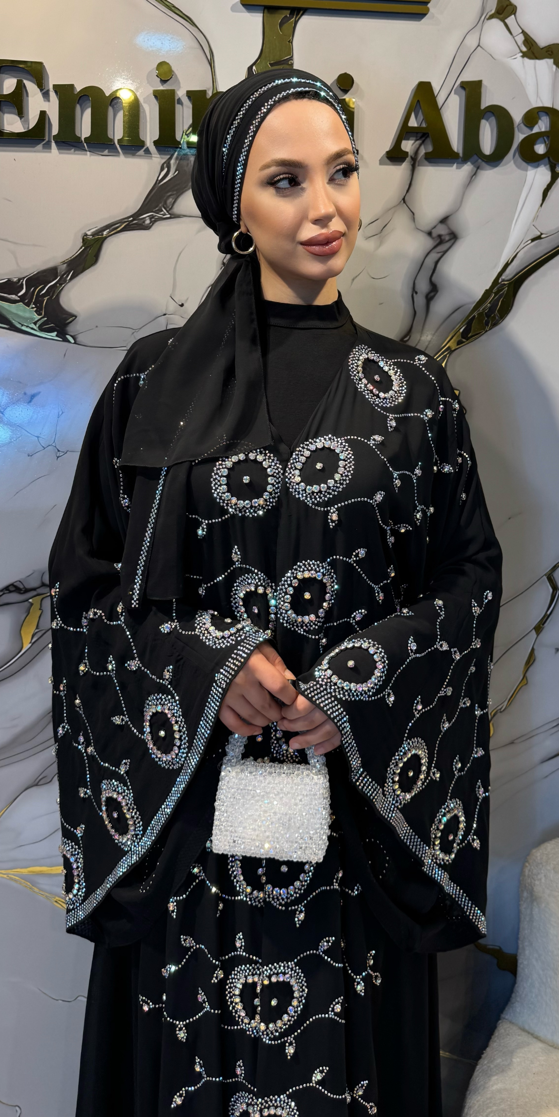 Black chiffon abaya embellished with JanJan stones on the front.