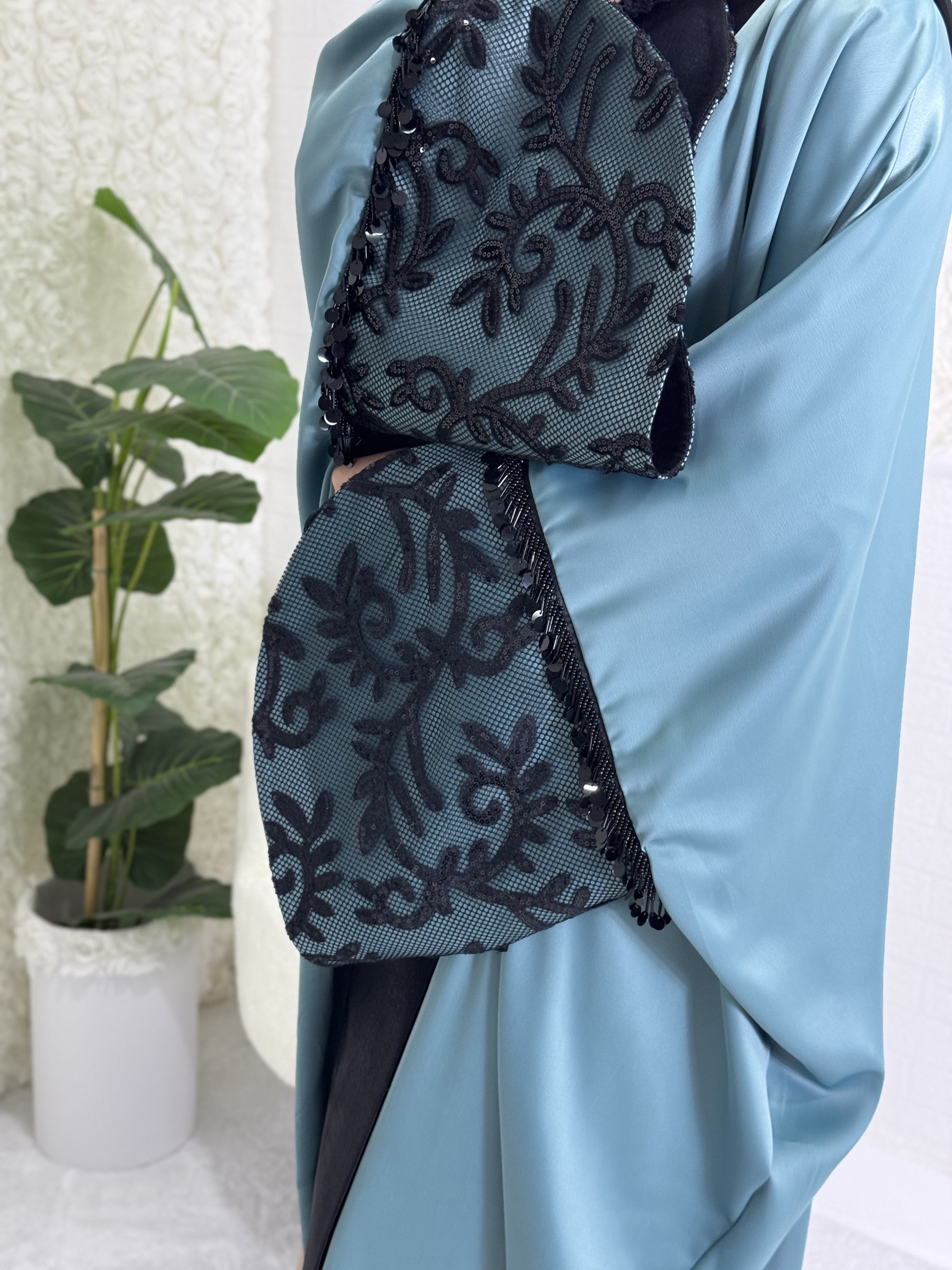 Turquoise satin abaya with black lace sleeves