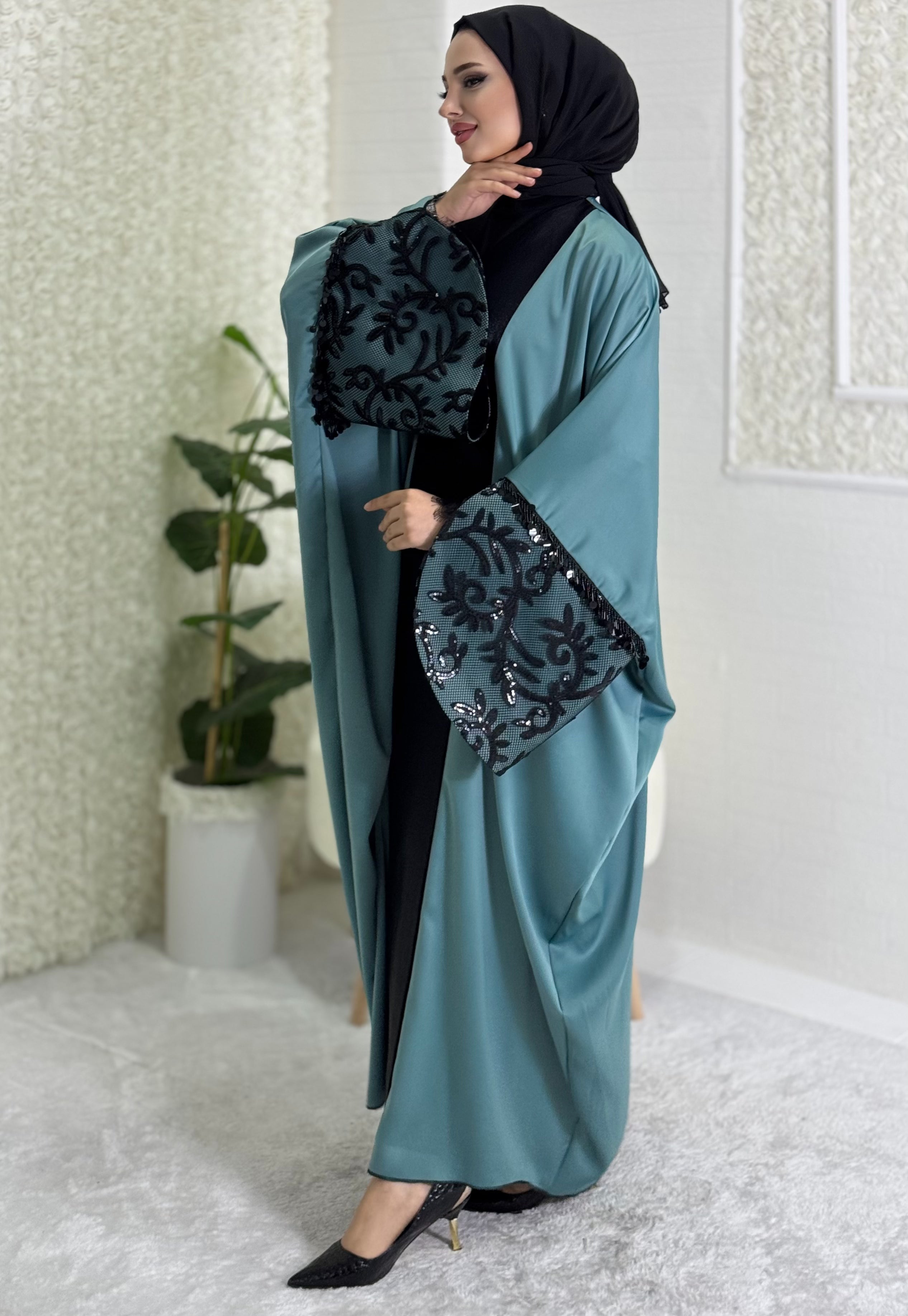 Turquoise satin abaya with black lace sleeves